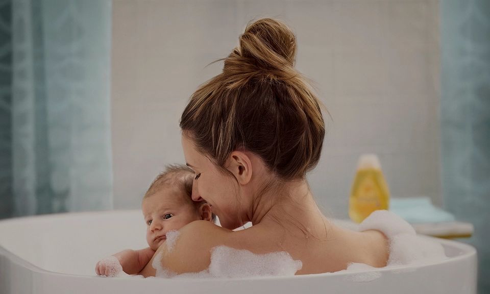 Article card Who says baby products aren’t for adults? Image of a mother and her baby on bath tube