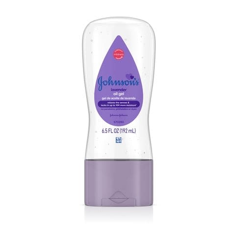 A lavender Johnson's Baby Oil Gel tube with chamomile sits upright against a white background. Text on label: "Clinically Proven Mildness," "Johnson's Baby Oil Gel," "with chamomile," and "6.5 FL OZ (192 mL)."