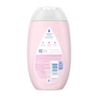 A light pink bottle of Johnson's baby lotion with a logo at the top of the label. The label also includes product information and a barcode on the lower right side. Recycling details are provided at the bottom.