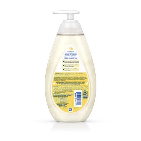 A semi-transparent bottle with a pump dispenser contains liquid. It is labeled “Johnson's CottonTouch Newborn Wash & Shampoo” with product details in English and Spanish on the back against a white background.