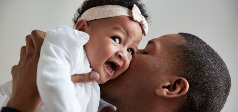 Johnson's Baby father kissing baby image