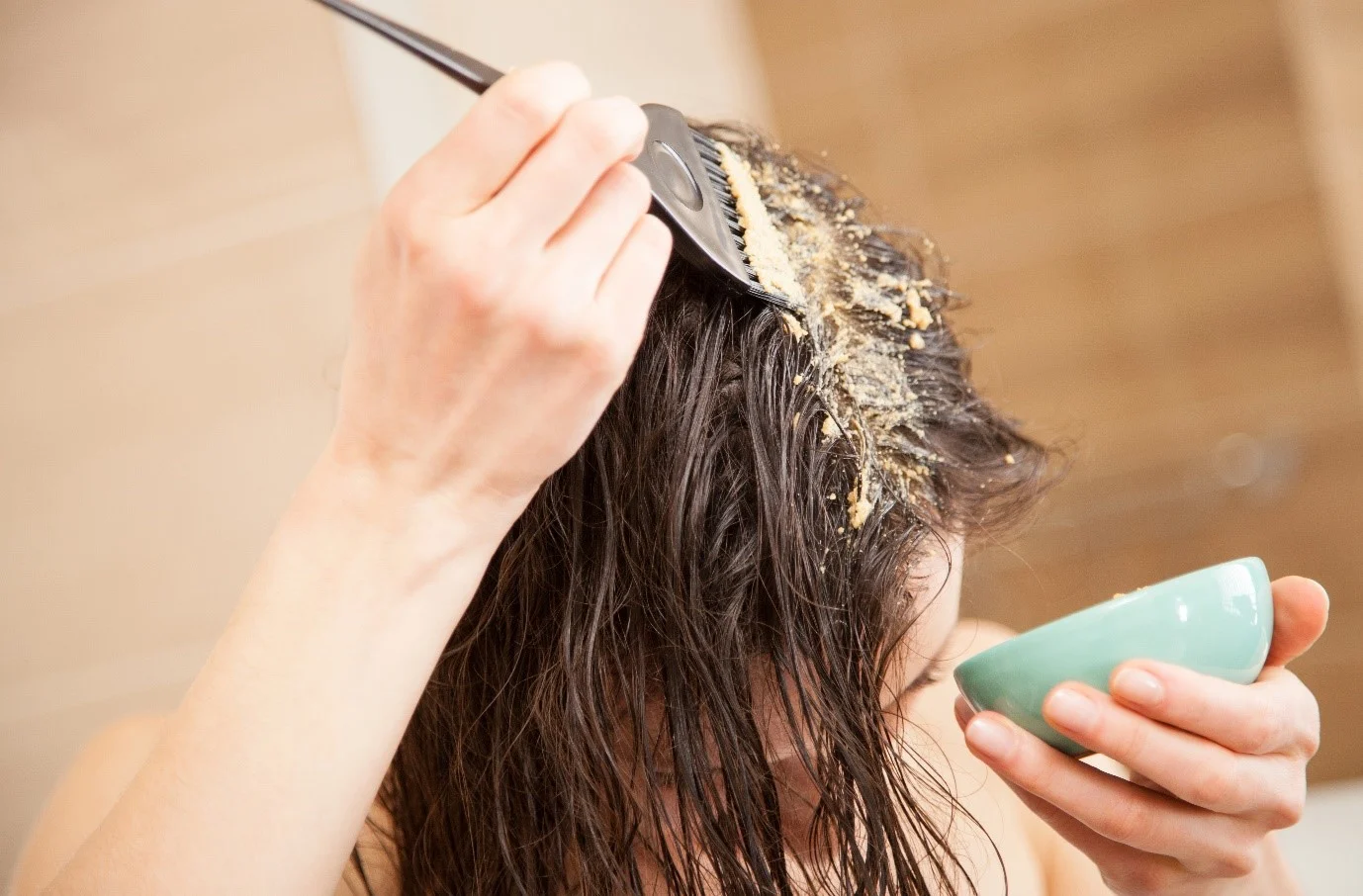 Woman applying hair mask