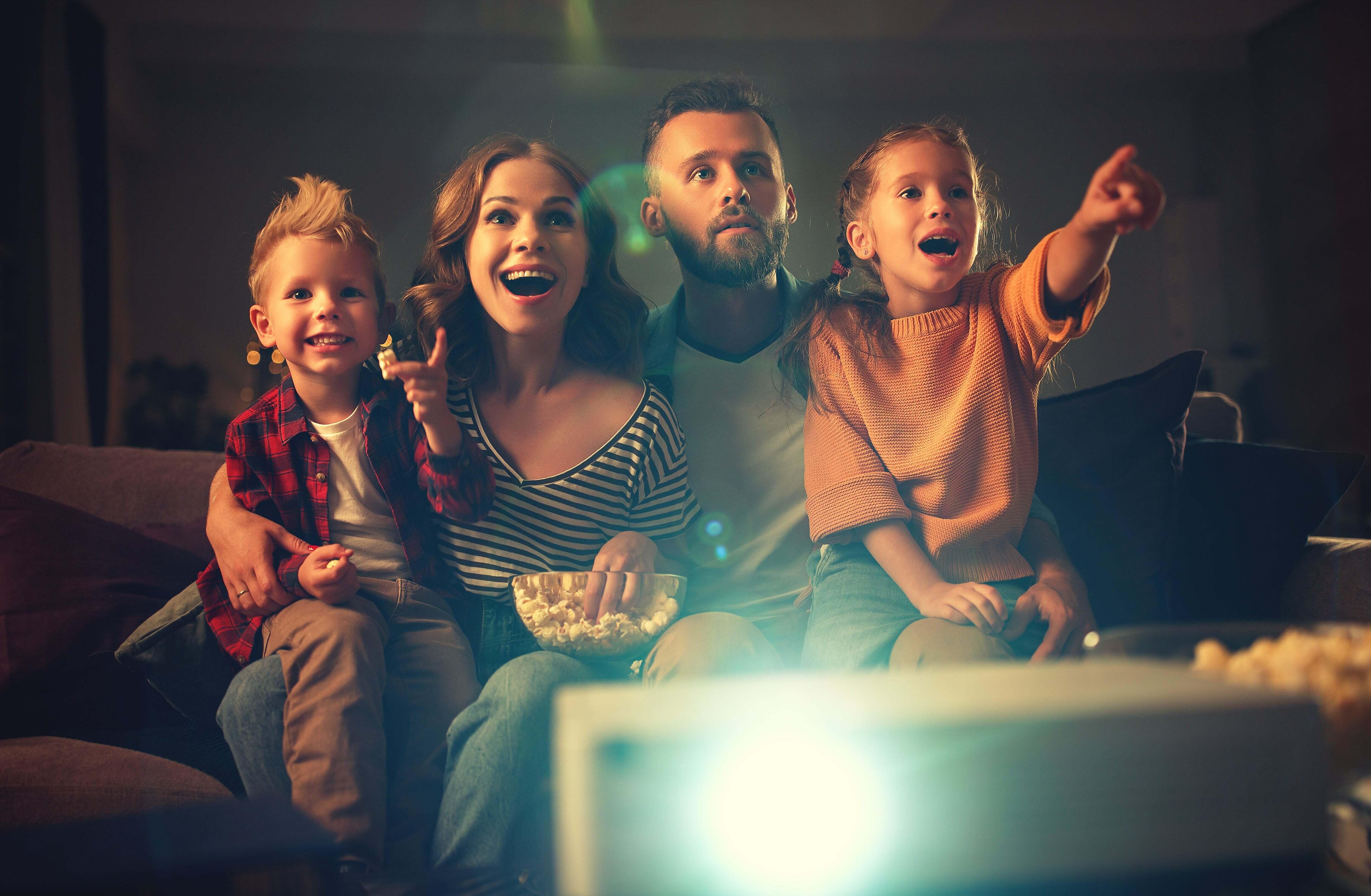 A family watching a show playing from a projector