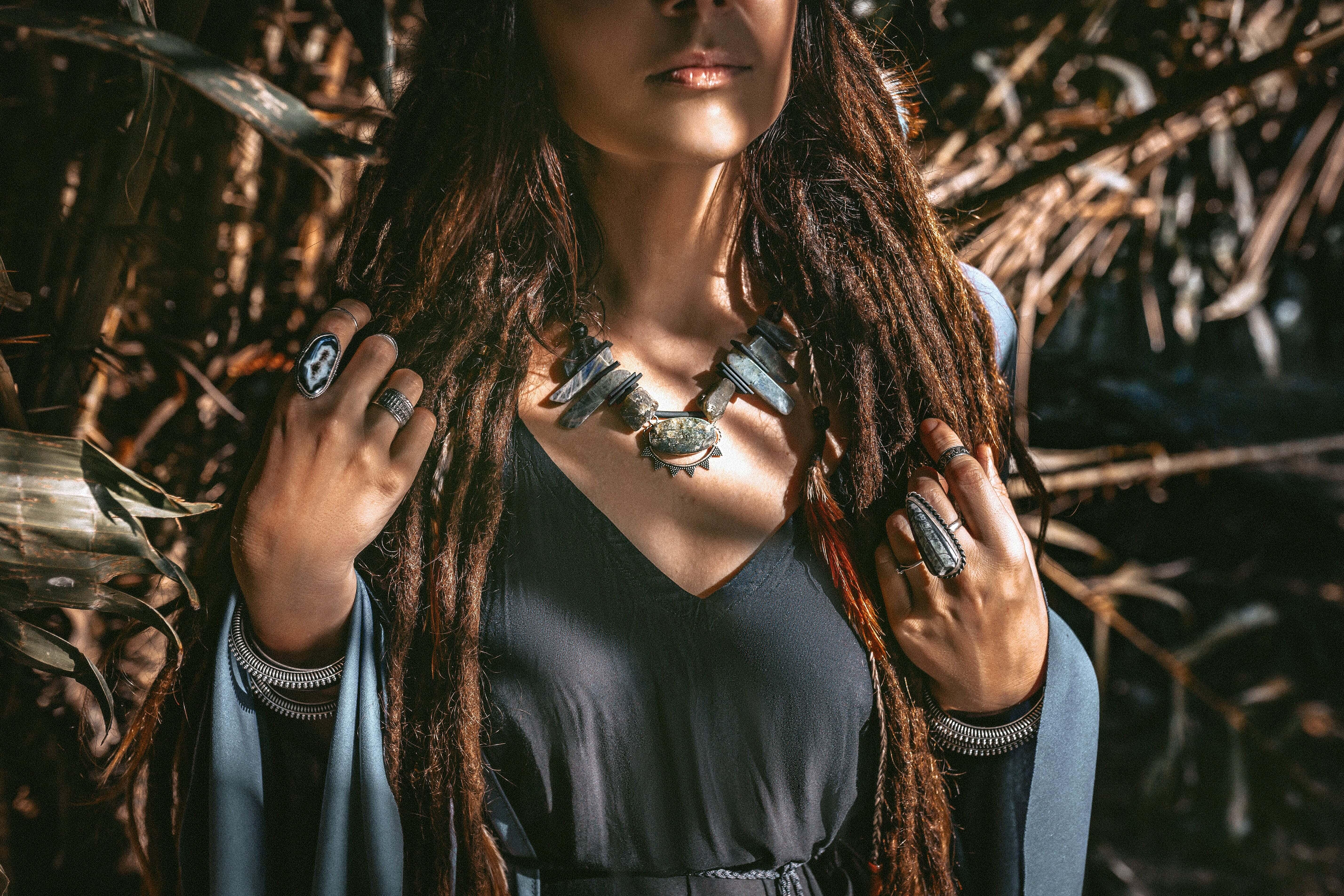 A woman wearing several pieces of gemstone jewelry