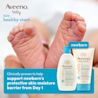 Front shot of Aveeno® Baby Healthy Start Newborn Wash and Balm products and a newborn baby's feet in the background