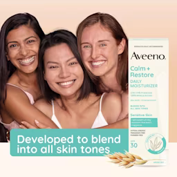 Three multicultural young women hugging and smiling