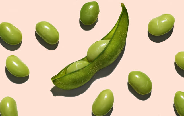 soy pods and bean flatlay on peach background