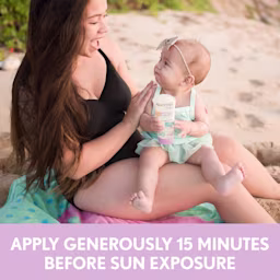 Woman applying Aveeno® sunscreen on her baby and text apply sunscreen 15 minutes before sun exposure