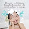 Jeune enfant souriant dans son bain qui utilise le shampoing et revitalisant hydratant AVEENO® Kids