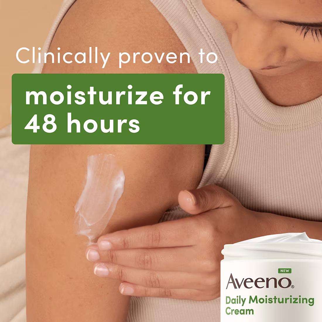 A woman wearing a beige tank top applies daily moisturizing cream to her arm. The cream is white and she is using her left hand to apply it. The background is a neutral beige color. The image says, "Clinically proven to moisturize for 48 hours."