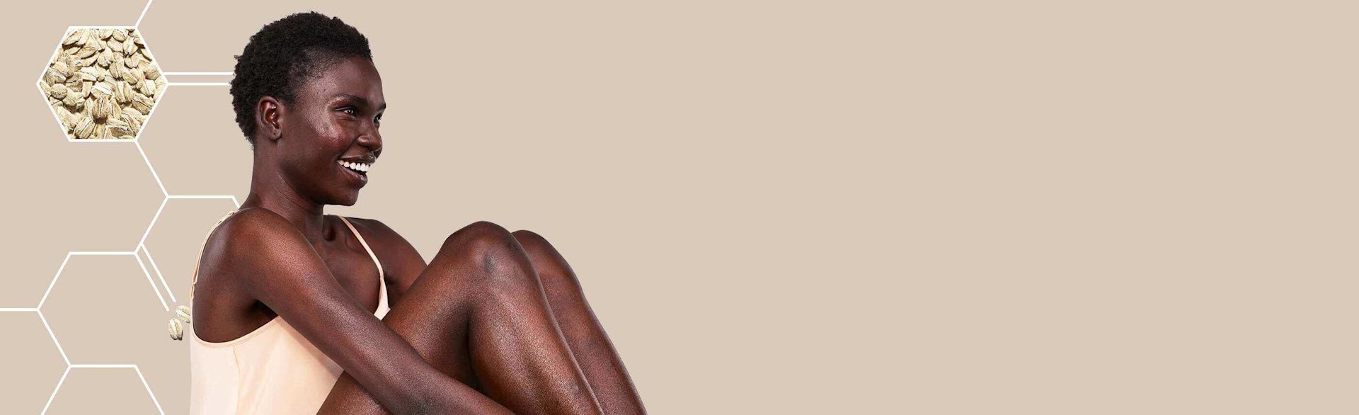 modelo da aveeno a sorrir e a olhar para baixo com uma pele brilhante