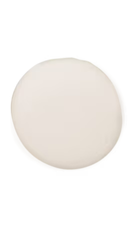 Matte off-white cream on a white surface showcasing its lightweight texture and uniform color