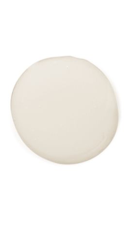 Matte off-white cream on a white surface showcasing its lightweight texture and uniform color
