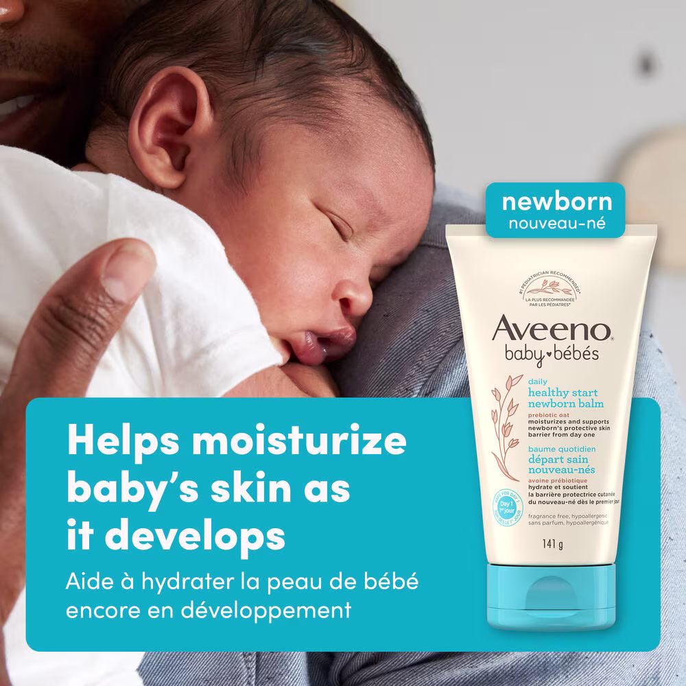 Front shot of Aveeno® Baby Healthy Start Newborn Balm, 141g, squeeze tube, and a baby on parent's shoulder sleeping in the background