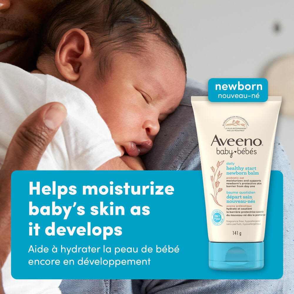 Front shot of Aveeno® Baby Healthy Start Newborn Balm, 141g, squeeze tube, and a baby on parent's shoulder sleeping in the background