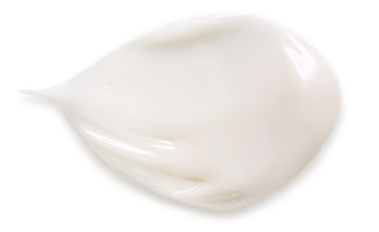 A delicate white cream positioned on a white surface showcasing its soft texture and uniform color