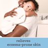 Man gently holds a baby in a bathroom showcasing a tender moment of care and connection between them