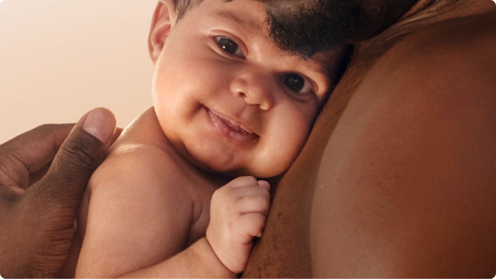 Aveeno® All Baby Products Banner - A father holding his baby in his arms