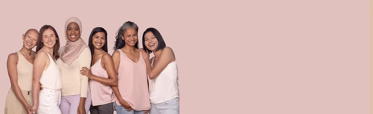 Six women from different ethnicities are standing together and smiling