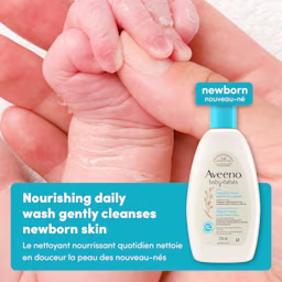 A4 Healthy Start Newborn Wash English French 2000x2000 Gently Cleanse JPG Front shot of Aveeno® Baby Healthy Start Newborn Wash squeeze bottle, 236ml, and baby's hand holding mother's hand in the background