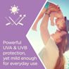 Woman holding baby in the air with graphic sun protection claim "Powerful UVA & UVB protection yet mild enough for everyday use