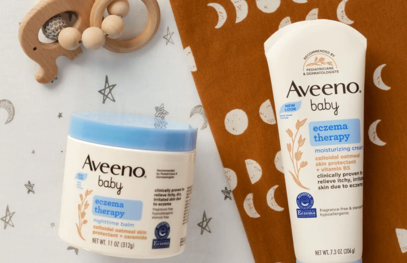 Aveeno® Baby Eczema Therapy Nighttime Cream, Eczema Therapy Moisturizing Cream and a wooden baby toy
