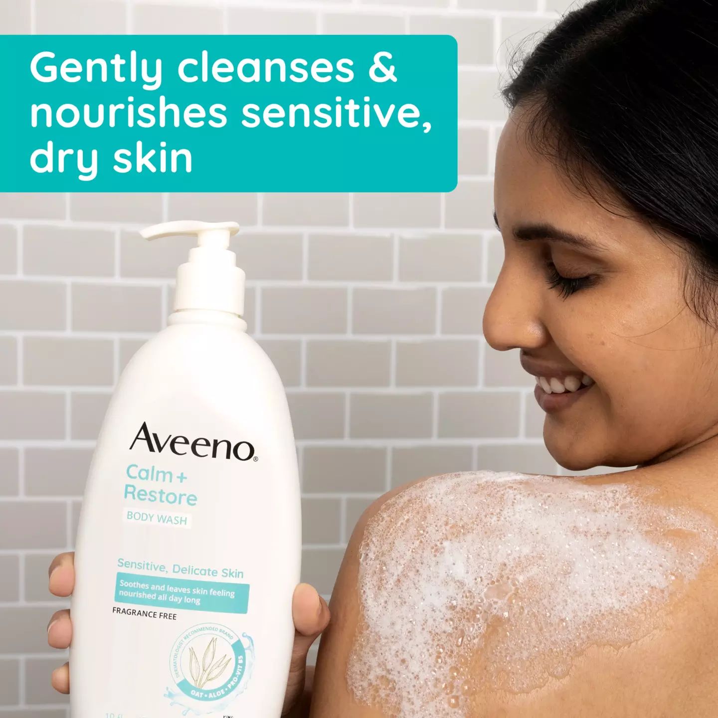 Woman bathing with Aveeno® Calm + Restore Body Wash bottle cleanses & nourishes sensitive dry skin
