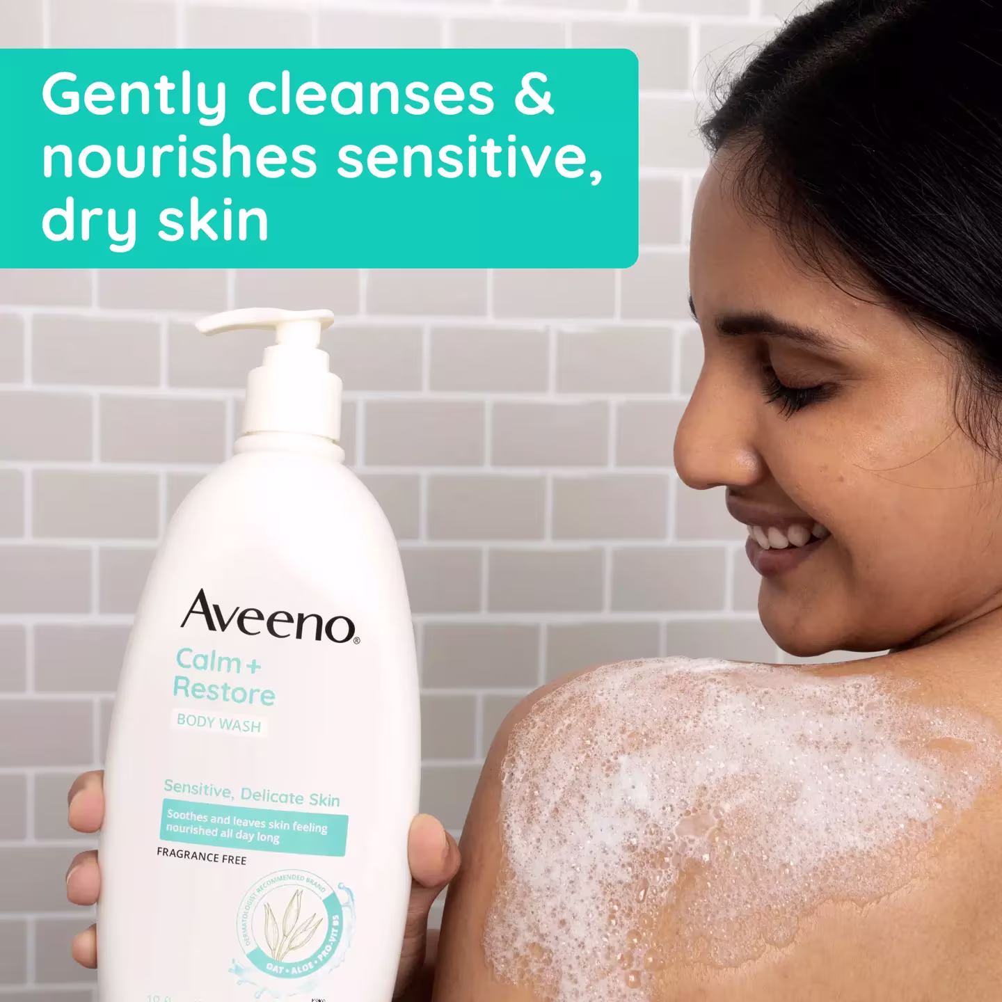 3 200465049 ave cr 381371187867 1 benefit Woman bathing with Aveeno® Calm + Restore Body Wash bottle cleanses & nourishes sensitive dry skin