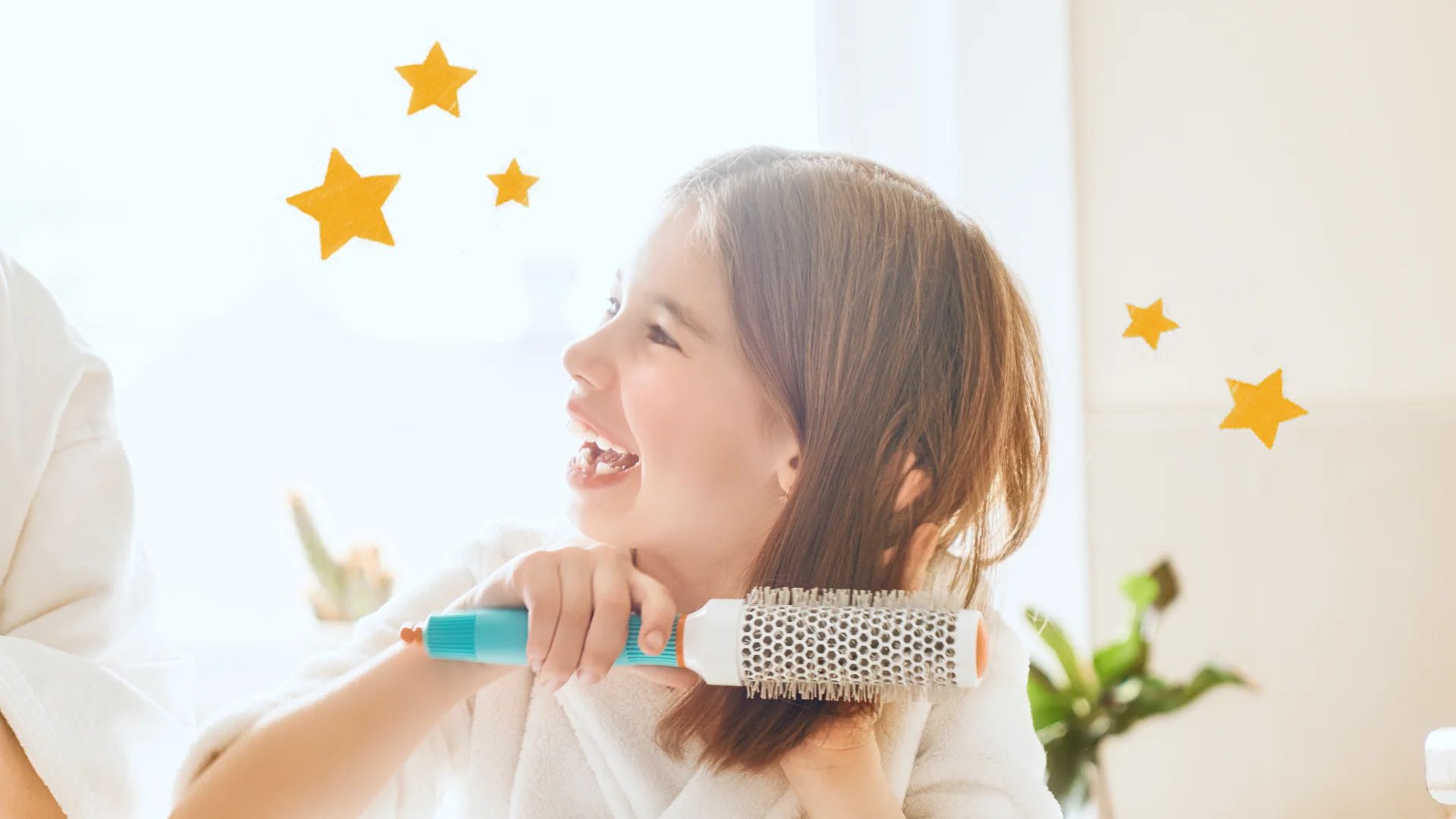 A young girl uses a hairbrush to style her hair, smiling with handsome joy