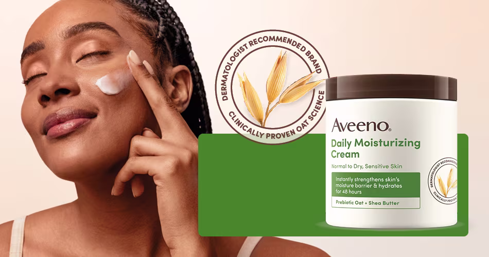 Woman smiling next to a jar of the Aveeno® Daily Moisturizing Cream.