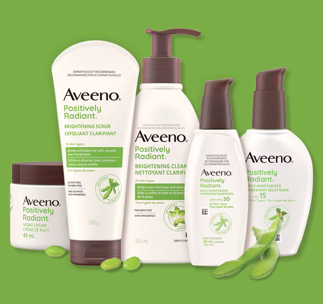 Five Aveeno® Positively Radiant Skin Care Products and soy beans.