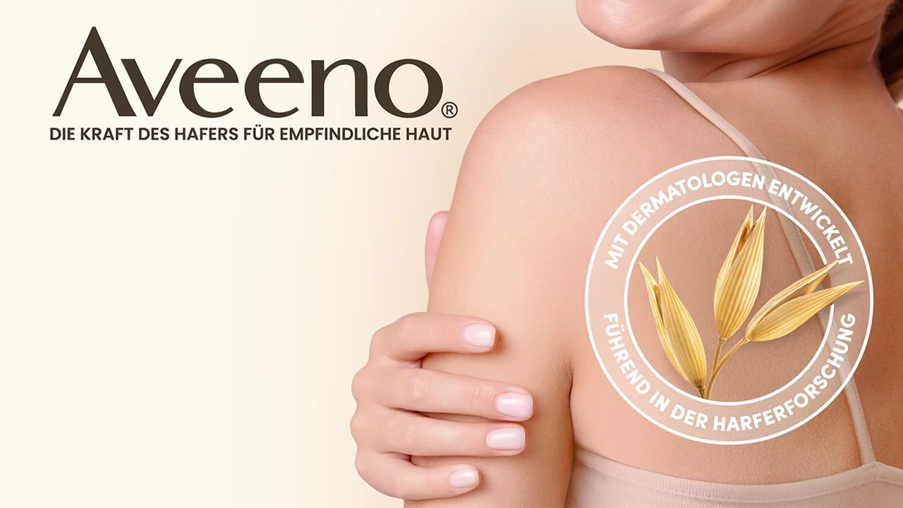 Aveeno - síla ovsa pro citlivou pokožku - modelka dívající se přes rameno - pečeť s ovsem a textem „vyvinuté s dermatology“ a „lídr ve výzkumu ovsa“)