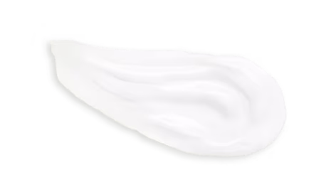 Shiny white cream on a white surface showcasing its thicker texture and uniform color