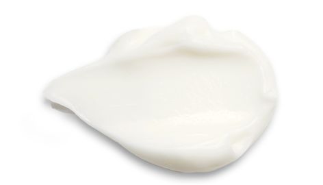 White cream on a white surface showcasing a soft, thicker texture