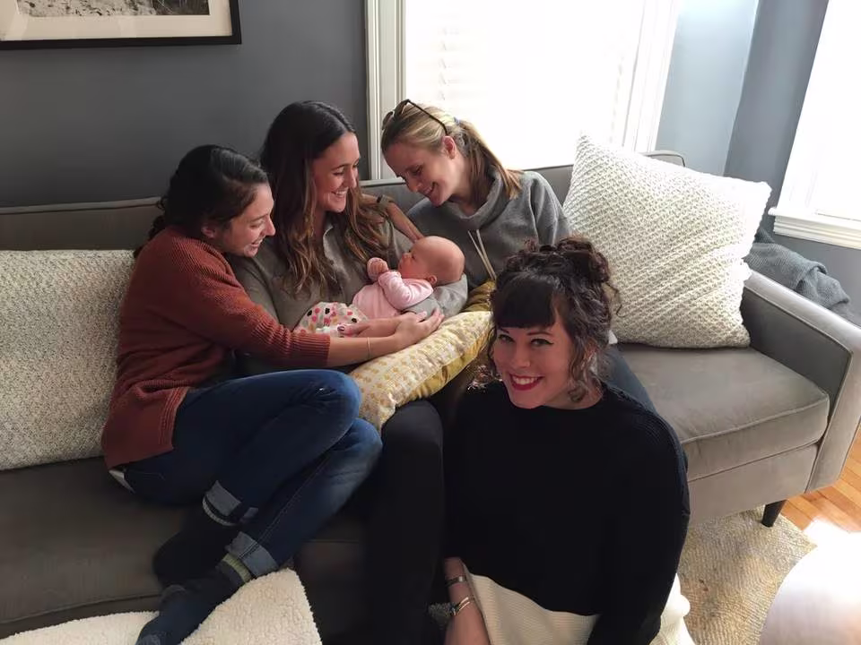 Wistians sitting on Meredith's couch with her new daughter