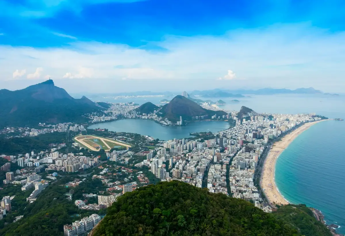 Aerial view of Rio de Janeiro with mountains, the lagoon, city buildings, and a long beach