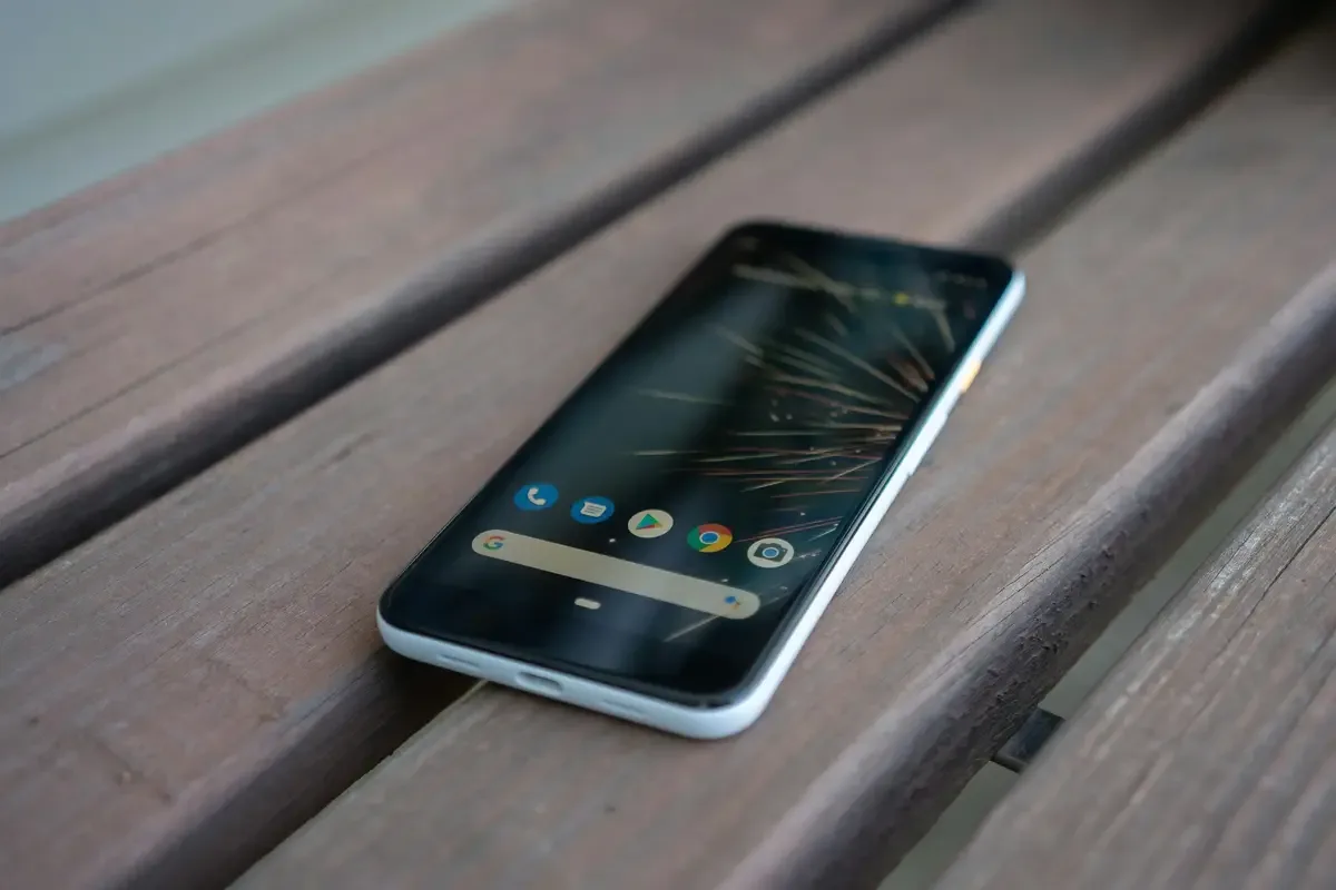 Android smartphone lying on a wooden bench