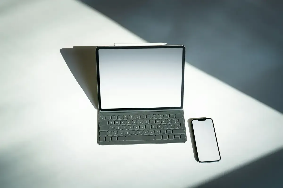 Tablet with keyboard and smartphone on a surface