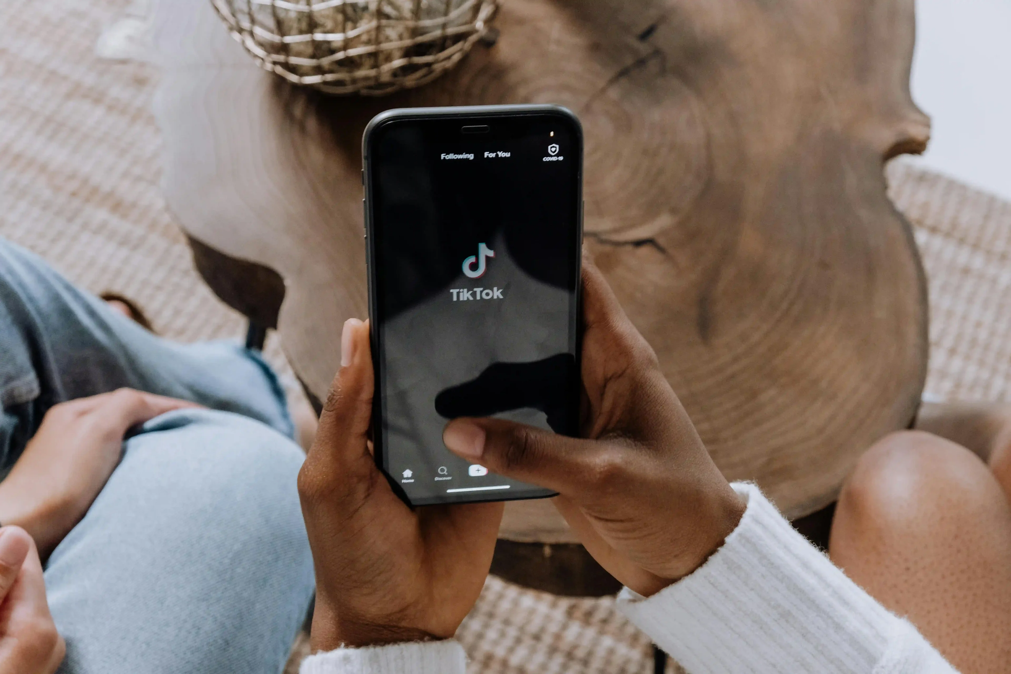 person using TikTok on smartphone