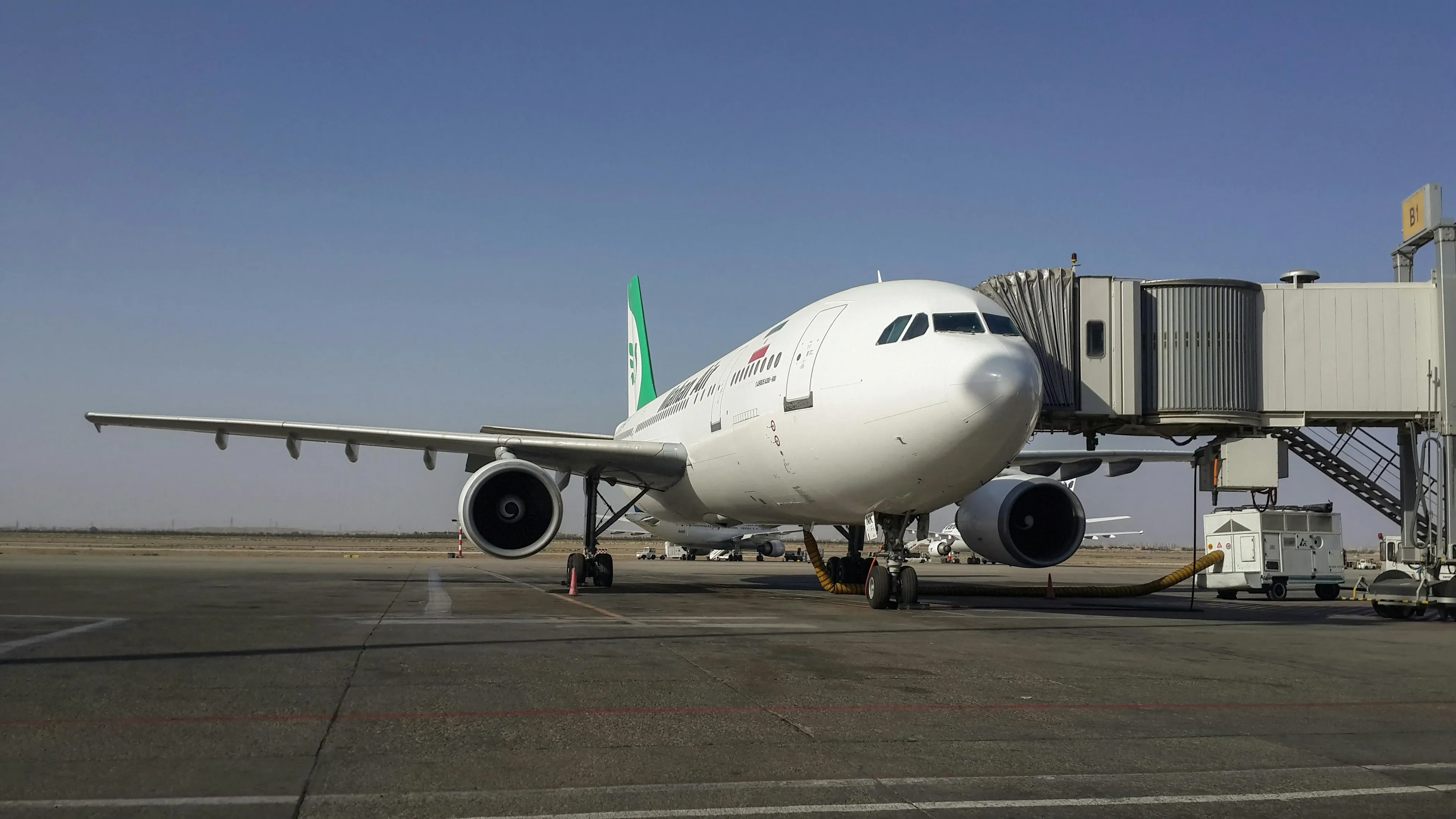 The white airplane located at the airport