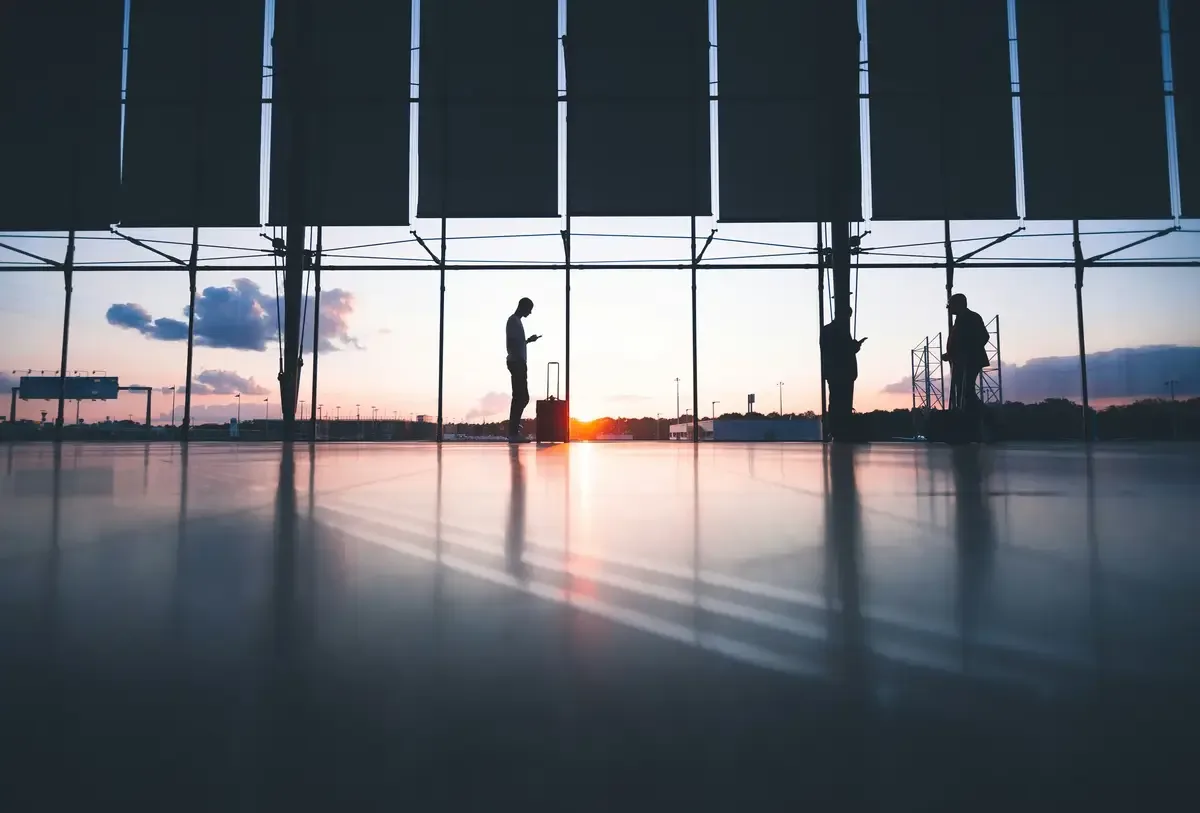 an airport terminal and passengers