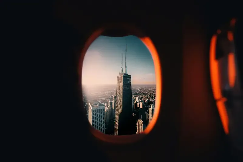 an airplane window and skyscraper