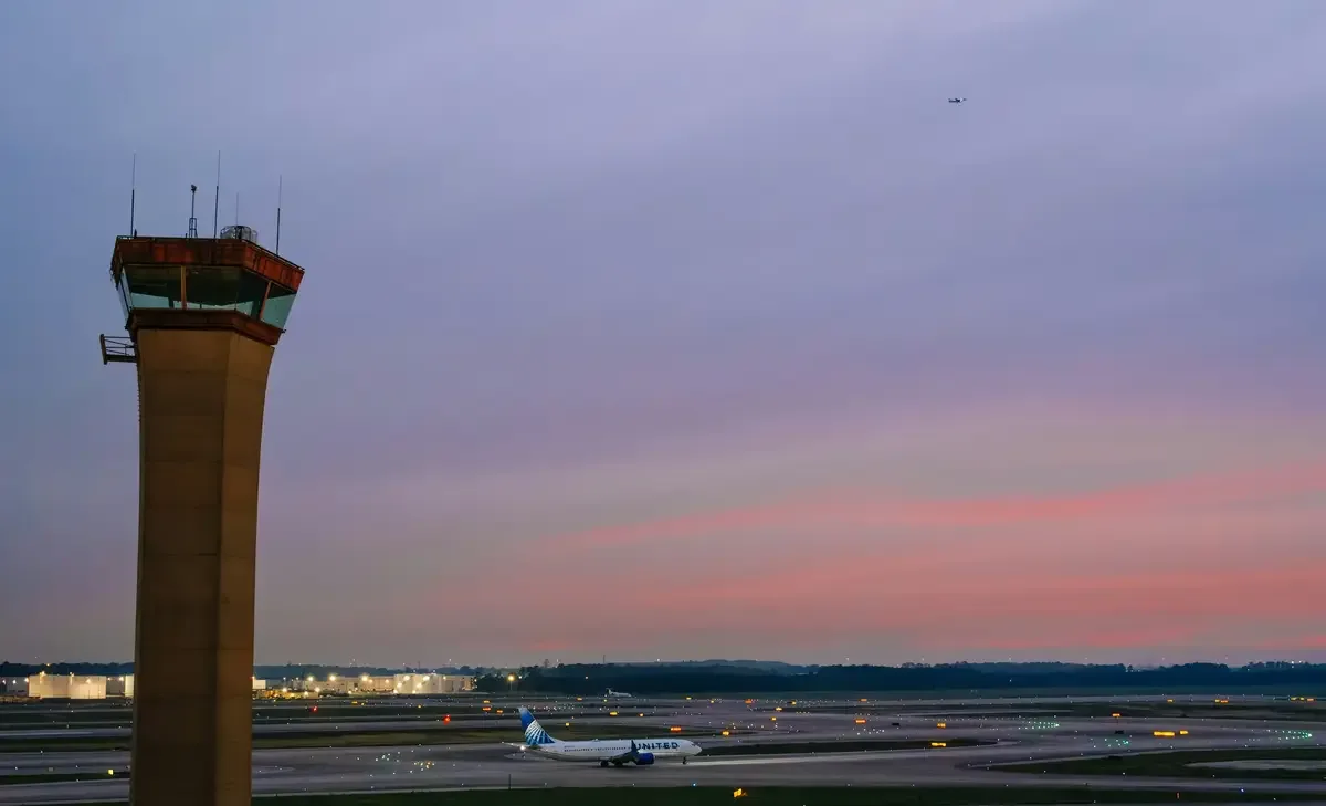 an airplane on airport runway and sunset