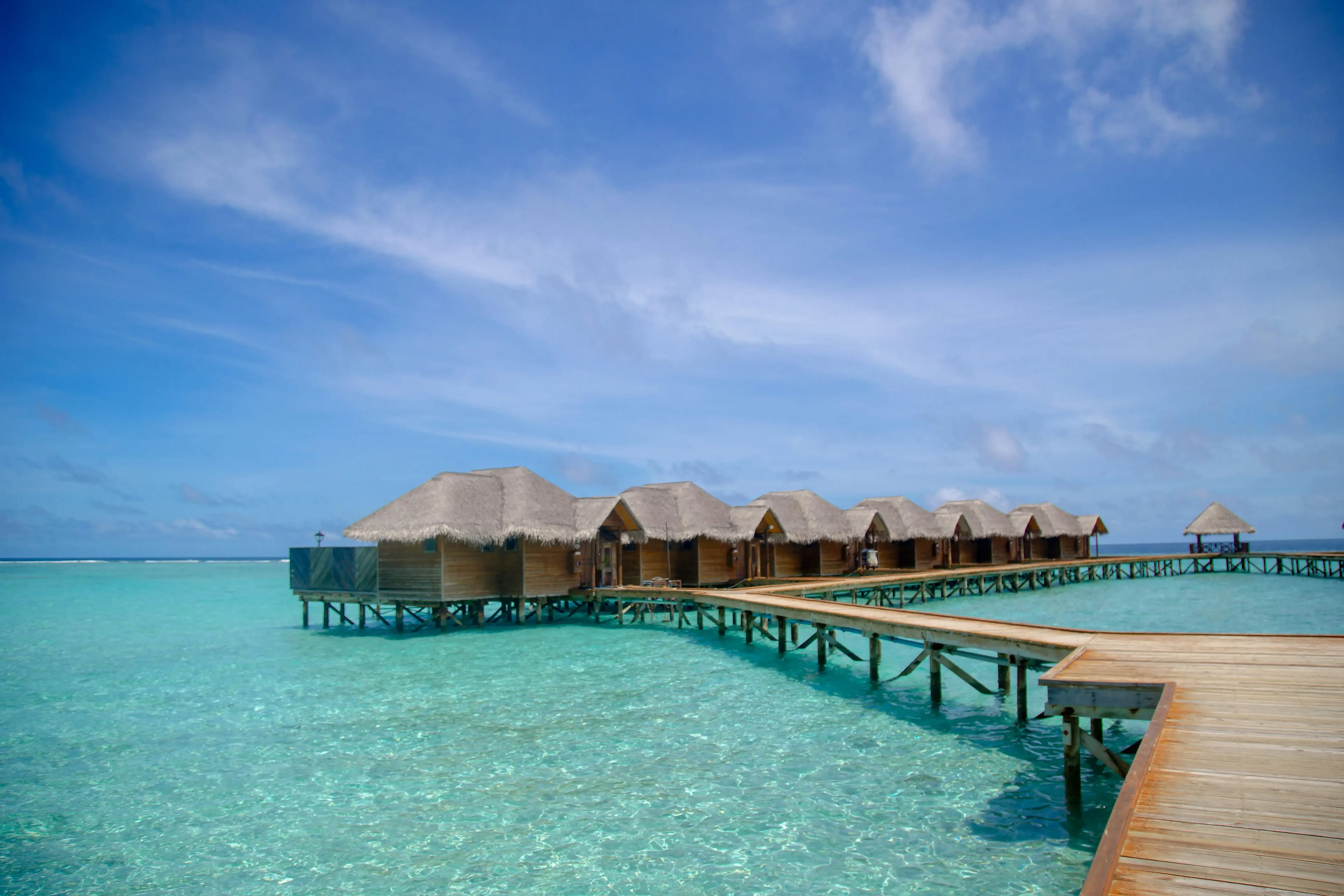 Wooden huts over the ocean and the beach