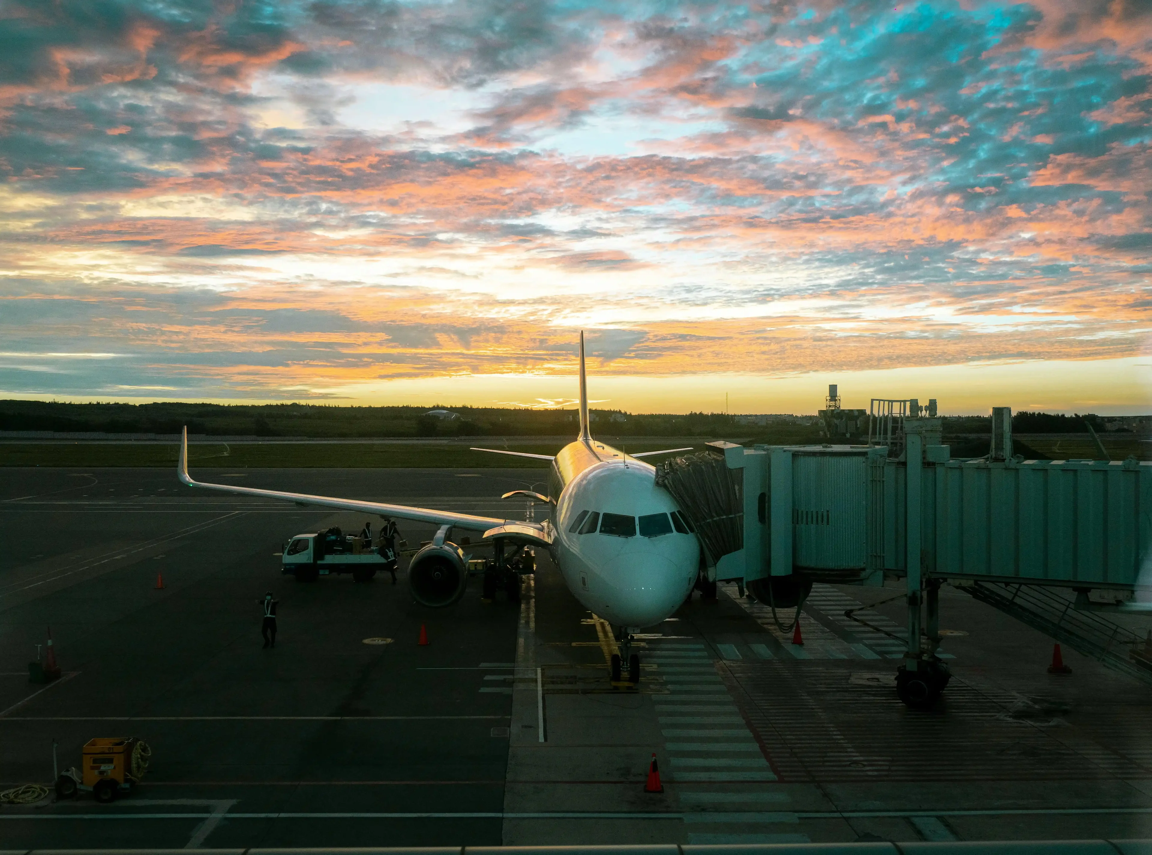 The airplane on the airport runway at sunset