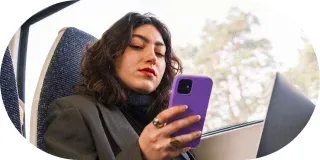 A traveller on a plane using her phone