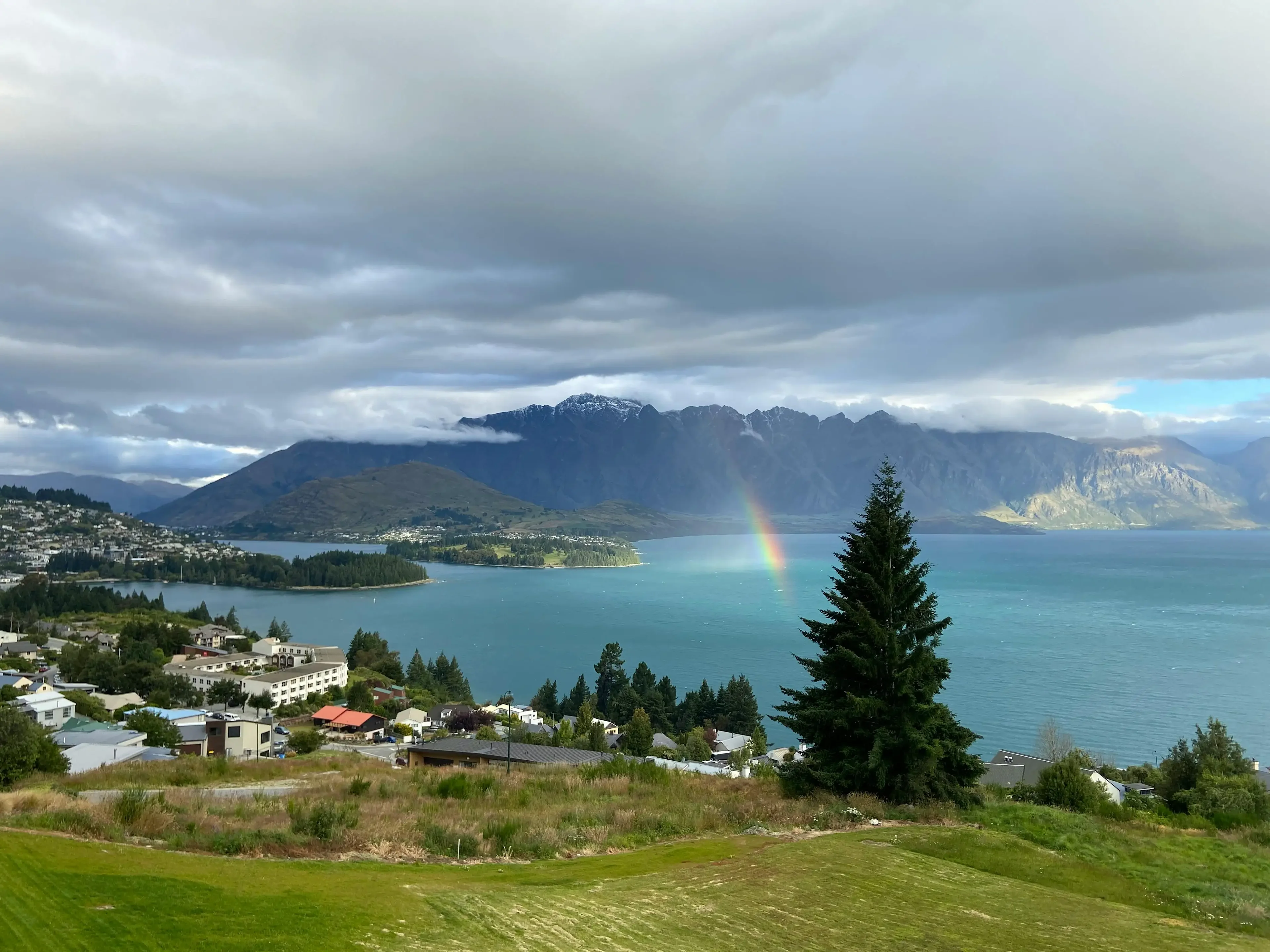 Mountain lake view with a rainbow in the sky