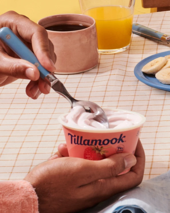 Hands scooping Tillamook Oregon Strawberry Yogurt