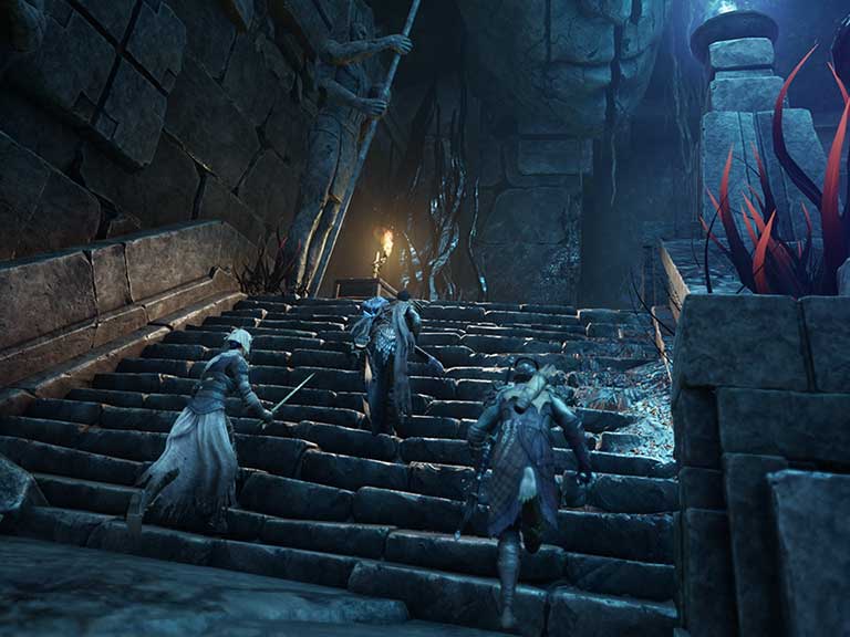 A group of adventurers with their weapons draw race up a flight of ancient stone stairs. The stairway is dimly lit with blue and orange flame sconces.