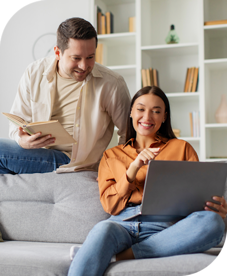 Man with coffee talking to woman with book on hand